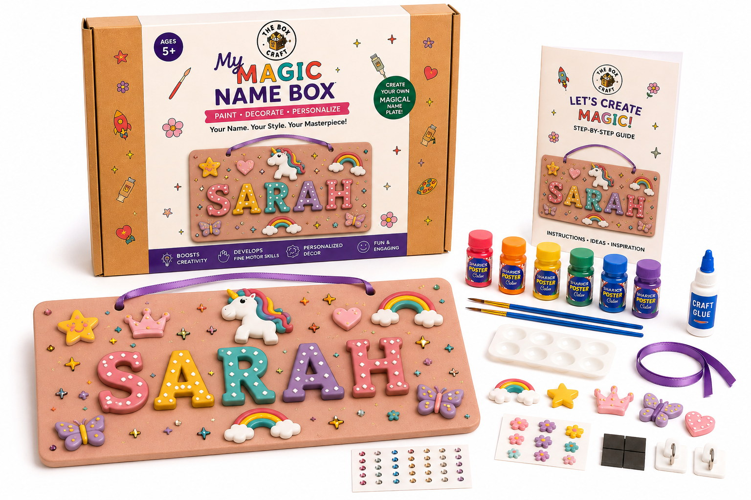 A children's craft kit called 'My Magic Name Box' shown with its packaging box, a completed wooden name box sample, a step-by-step guide, small paint bottles, brushes, ribbon, stickers, and other accessories on a white background.